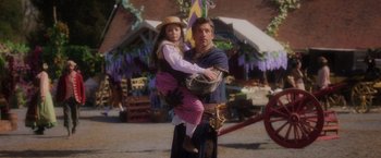 Movie still from “Disenchanted” (2022), directed by Adam Shankman – A man and a little girl are standing together; Medium shot, Over the shoulder angle