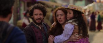 Movie still from “Disenchanted” (2022), directed by Adam Shankman – A man , woman , and a little girl standing next to each other; Close Up shot, Over the shoulder angle