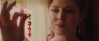 Movie still from “Disenchanted” (2022), directed by Adam Shankman – A woman's face in front of a mirror; Close Up shot, Over the shoulder angle