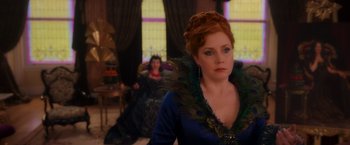 Movie still from “Disenchanted” (2022), directed by Adam Shankman – A woman in a peacock inspired dress and a woman in a peacock inspired dress; Medium shot, Over the shoulder angle