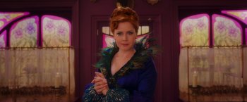 Movie still from “Disenchanted” (2022), directed by Adam Shankman – A woman in a peacock inspired outfit; Medium shot, Over the shoulder angle