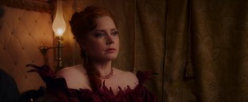 Movie still from “Disenchanted” (2022), directed by Adam Shankman – A woman with red hair wearing a red dress; Close Up shot, Over the shoulder angle