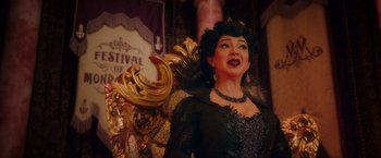 Movie still from “Disenchanted” (2022), directed by Adam Shankman – A woman wearing a black dress and a crown; Medium shot, Over the shoulder angle