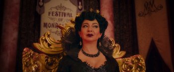 Movie still from “Disenchanted” (2022), directed by Adam Shankman – A woman dressed as a queen in front of a gold frame; Close Up shot, Over the shoulder angle