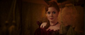 Movie still from “Disenchanted” (2022), directed by Adam Shankman – A woman with red hair wearing a red dress; Close Up shot, Over the shoulder angle