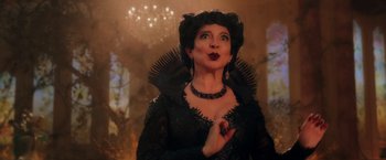 Movie still from “Disenchanted” (2022), directed by Adam Shankman – A woman dressed as a witch in a black dress; Close Up shot, Over the shoulder angle