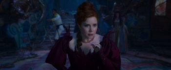 Movie still from “Disenchanted” (2022), directed by Adam Shankman – A red haired woman in a purple dress; Medium shot, Over the shoulder angle