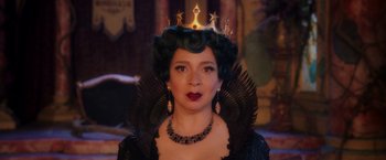 Movie still from “Disenchanted” (2022), directed by Adam Shankman – A woman wearing a black dress with a crown on her head; Close Up shot, Over the shoulder angle