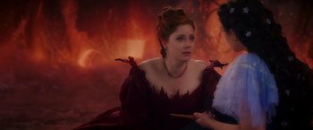 Movie still from “Disenchanted” (2022), directed by Adam Shankman – A woman in a red dress sitting next to another woman in a red dress; Close Up shot, Over the shoulder angle