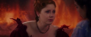 Movie still from “Disenchanted” (2022), directed by Adam Shankman – A woman wearing a necklace and a red dress; Close Up shot, Over the shoulder angle