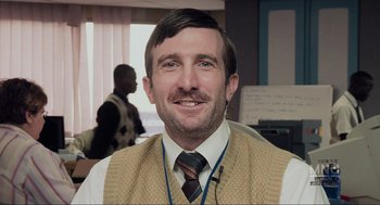 Movie still from “District 9” (2009), directed by Neill Blomkamp – A person wearing a tie; Close Up shot, Over the shoulder angle