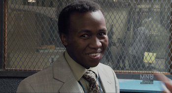 Movie still from “District 9” (2009), directed by Neill Blomkamp – A person wearing a suit and a tie; Close Up shot, Low angle