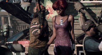 Movie still from “District 9” (2009), directed by Neill Blomkamp – A woman in a purple dress holding a gun; Medium shot, Low angle