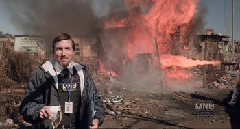 Movie still from “District 9” (2009), directed by Neill Blomkamp – A police officer standing in front of a burning building; Medium shot, Low angle