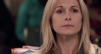 Movie still from “District 9” (2009), directed by Neill Blomkamp – A person with long blonde hair; Close Up shot, Over the shoulder angle