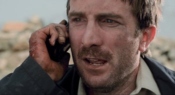 Movie still from “District 9” (2009), directed by Neill Blomkamp – A person talking on a cell phone; Close Up shot, Low angle