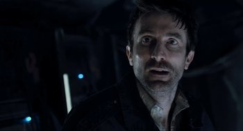 Movie still from “District 9” (2009), directed by Neill Blomkamp – A person wearing a jacket; Close Up shot, Over the shoulder angle