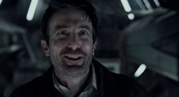 Movie still from “District 9” (2009), directed by Neill Blomkamp – A person wearing a jacket; Close Up shot, Over the shoulder angle