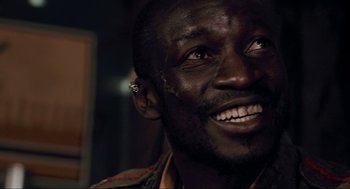 Movie still from “District 9” (2009), directed by Neill Blomkamp – A person smiling; Close Up shot, High angle
