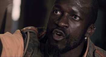 Movie still from “District 9” (2009), directed by Neill Blomkamp – A person with a beard; Close Up shot, Low angle