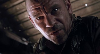 Movie still from “District 9” (2009), directed by Neill Blomkamp – A man's face in a dark room; Close Up shot, Low angle