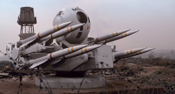Movie still from “District 9” (2009), directed by Neill Blomkamp – An airplane with many missiles on top of it; Wide shot, Low angle