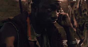 Movie still from “District 9” (2009), directed by Neill Blomkamp – A person with a cell phone; Close Up shot, Over the shoulder angle