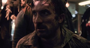 Movie still from “District 9” (2009), directed by Neill Blomkamp – A person wearing a jacket; Close Up shot, Over the shoulder angle