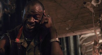 Movie still from “District 9” (2009), directed by Neill Blomkamp – A person talking on a cell phone; Close Up shot, Low angle