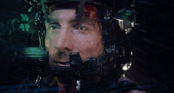 Movie still from “District 9” (2009), directed by Neill Blomkamp – A person wearing a helmet; Close Up shot, Overhead angle