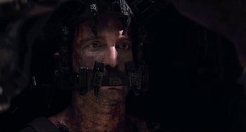 Movie still from “District 9” (2009), directed by Neill Blomkamp – A person wearing a helmet; Close Up shot, Over the shoulder angle