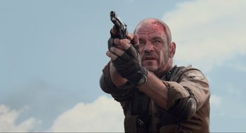 Movie still from “District 9” (2009), directed by Neill Blomkamp – A man with a gun in his hand; Close Up shot, Low angle