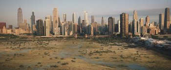 Movie still from “Divergent” (2014), directed by Neil Burger – An aerial view of a large city with tall skyscrapers; Extreme Wide shot, High angle