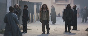 Movie still from “Divergent” (2014), directed by Neil Burger – A group of people standing on a sidewalk; Wide shot, Low angle