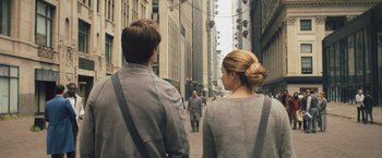 Movie still from “Divergent” (2014), directed by Neil Burger – A man and a woman walking down a street; Medium shot, Over the shoulder angle