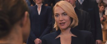 Movie still from “Divergent” (2014), directed by Neil Burger – A person wearing a suit and tie; Close Up shot, Over the shoulder angle