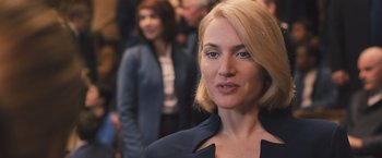Movie still from “Divergent” (2014), directed by Neil Burger – A person wearing a suit; Close Up shot, Over the shoulder angle