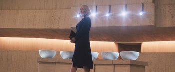 Movie still from “Divergent” (2014), directed by Neil Burger – A woman in a black dress holding a black purse; Medium shot, Low angle