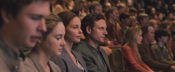 Movie still from “Divergent” (2014), directed by Neil Burger – A group of people sitting next to each other in a room; Medium shot, Over the shoulder angle