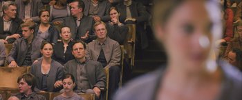 Movie still from “Divergent” (2014), directed by Neil Burger – A group of people sitting in chairs in a room; Medium shot, High angle