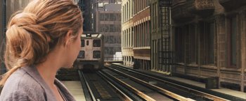 Movie still from “Divergent” (2014), directed by Neil Burger – A woman standing in front of a train on the tracks; Extreme Close Up shot, High angle