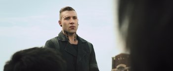 Movie still from “Divergent” (2014), directed by Neil Burger – A man in a black jacket with a tattoo on his neck; Close Up shot, Low angle