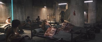 Movie still from “Divergent” (2014), directed by Neil Burger – A group of people sitting around in a room; Wide shot, High angle