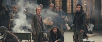 Movie still from “Divergent” (2014), directed by Neil Burger – A group of people standing around in the street; Wide shot, Low angle