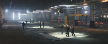 Movie still from “Divergent” (2014), directed by Neil Burger – A group of people standing in an industrial setting; Extreme Wide shot, High angle