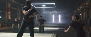 Movie still from “Divergent” (2014), directed by Neil Burger – A man standing in the middle of an empty room; Wide shot, Low angle