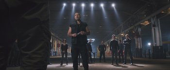 Movie still from “Divergent” (2014), directed by Neil Burger – A group of people standing in an industrial setting; Wide shot, Low angle