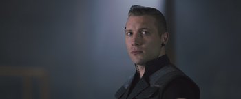 Movie still from “Divergent” (2014), directed by Neil Burger – A person wearing a jacket and looking into the distance; Close Up shot, Over the shoulder angle