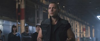 Movie still from “Divergent” (2014), directed by Neil Burger – A man in a black shirt and a black vest; Close Up shot, Low angle