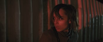 Movie still from “Divergent” (2014), directed by Neil Burger – A young woman with headphones looking into the distance; Close Up shot, Low angle